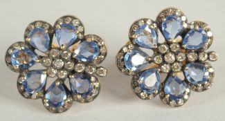 A PAIR OF SAPPHIRE AND DIAMOND FLOWER SHAPE CLUSTER EAR STUDS.