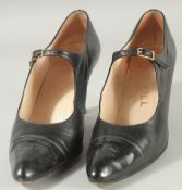 A PAIR OF CHANEL BLACK LEATHER SHOES with buckles and patent toes. Size 38.