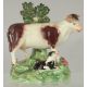 A STAFFORDSHIRE BOCAGE GROUP OF A COW AND CALF 5.5ins high. - Image 1 of 3