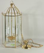 A GILT METAL OCTAGONAL HANGING LANTERN. 26ins long.