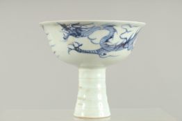 A CHINESE BLUE AND WHITE STEM CUP the sides with dragons. 4.5ins high.