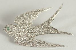 AN 18CT WHITE GOLD DIAMOND SET SWALLOW BROOCH.