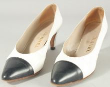 A PAIR OF CHANEL LEATHER WHITE SHOES with navy toe. Size 37.5.