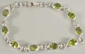 A SILVER PERIDOT SET BRACELET.