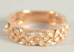 AN 18 CARAT ROSE GOLD AND DIAMOND THREE QUARTERS BANDED RING. Diamond 0.6 carat.