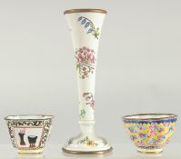 A SMALL ENAMEL SPECIMEN VASE painted with flowers. 5.25ins high and two enamel cups.