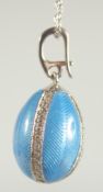 A TATIANA FABERGE STERLING SILVER AND ENAMEL EGG SHAPE PENDANT AND CHAIN.