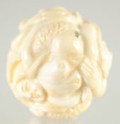 A CARVED BONE BALL carved with nudes