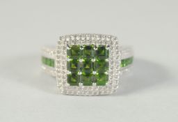 A SILVER, GREEN STONE AND CZ RING.