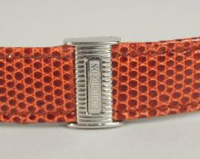 A BOUCHERON BROWN LEATHER STRAP in a Boucheron white leather case.