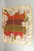 A CHRISTIAN DIOR SILK SCARF with panels and flowers, in original box. 87.5cm x 87.5cm.
