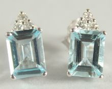 A PAIR OF 18 CARAT WHITE GOLD AQUAMARINE AND DIAMOND STUD EARRINGS.