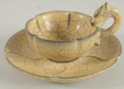 A CHINESE CRACKLE GLAZE TEA CUP AND SAUCER.