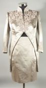 A CATHERINE WALKER TWO PIECE SILK TAUPE SKIRT AND JACKET SUIT, a plain skirt and tailed jacket