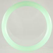 AN ICY CELADON JADE BANGLE. 3ins diameter.