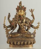 A GILT BRONZE MULTI ARMED DEITY set with beads. 8.5ins high.