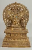 A GOOD GILT BRONZE BUDDHA AND SHRINE on a rectangular base. 11ins high.