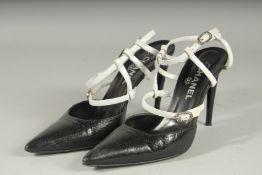A PAIR OF CHANEL BLACK AND WHITE HIGH HEEL SHOES, heel 4.5ins high, with diamante buckles. Size 39.5
