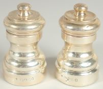 A PAIR OF SILVER SALT AND PEPPER.