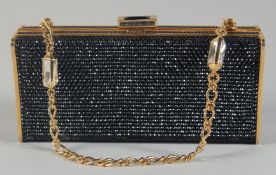 A JUDITH LEIBER, NEW YORK, BLACK BEAD EVENING BAG, with gilt interior, pocket mirror in a cloth bag.