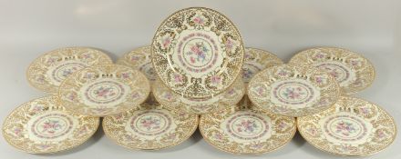 A SET OF TWELVE ROYAL IVORY FLORAL AND GILT PLATES. 11ins diameter.