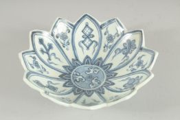 A CHINESE BLUE AND WHITE PORCELAIN PETAL SHAPE BOWL, with lucky symbol. 17.5cm diameter
