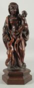 AN 18TH CENTURY CONTINENTAL CARVED WOOD MADONNA AND CHILD with a cupid, on a rectangular base. 1ft