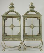 A LARGE PAIR OF COPPER RECTANGULAR LANTERNS on four curving legs. 28ins high.