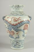 A LARGE CHINESE BLUE AND WHITE VASE with dragon decoration. 17ins high.
