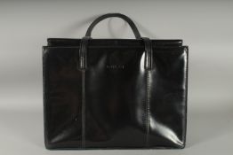 A LARGE GUCCI BLACK PATENT LEATHER BAG with large back pocket with toggle and zip, two straps,