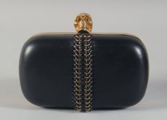 AN ALEXANDER MCQUEEN BLACK LEATHER BAG with single scull clasp and rope work. 6ins long, 3.25ins