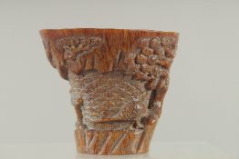 A SMALL CARVED HORN LIBATION CUP carved with birch and foliage. 4.5ins high, 4.75ins wide overall.