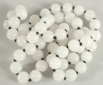 A STRING OF WHITE BEADS. 28ins long.