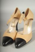 A PAIR OF CHANEL BEIGE AND BLACK LEATHER SLING BACK SHOES. Size 39 boxed.