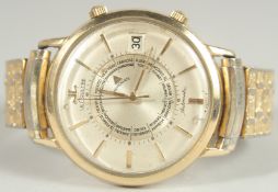 A RARE LE COULTRE MEMODATE AUTOMATIC WRIST WATCH with 10k gold filler case, later expanding strap.