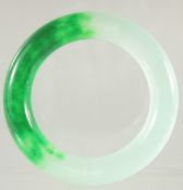 A HEAVY TWO TONE JADE BANGLE.