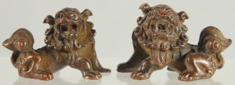 A SMALL PAIR OF BRONZE FOO DOGS. 2ins.