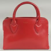 A RADLEY, LONDON, RED LEATHER BAG, with two short handles and long strap. 34cm long, 20cm high, 10cm