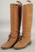 A PAIR OF CHANEL BROWN SUEDE BOOTS with lace detail, double C logo to front. Size 38.