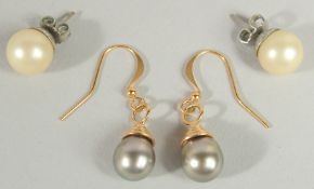 A PAIR OF SOUTH SEAS BLACK PEARL EARRINGS AND A PAIR OF WHITE PEARL STUDS.