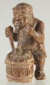 A WOODEN MAN PLAYING A DRUM. 2ins.
