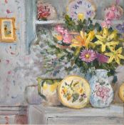 Modern British School, A still life of flowers in a vase on a cupboard and other objects on a shelf,
