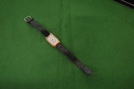 An unusual 9ct gold gentlemans wrist watch.