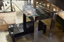 A stylish glass and chrome stand and a similar smaller stand.