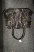 A DKNY black leather handbag.