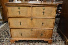 An 18th century design walnut straight front chest of two short and two long drawers.