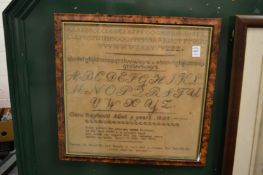 A sampler dated 1855, framed and glazed.