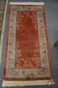 A Chinese rug 145cm x 70cm.