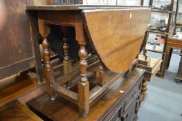 A 19th century oak oval gateleg dining table.