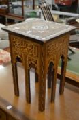 An Islamic occasional table with mother of pearl inlaid decoration.